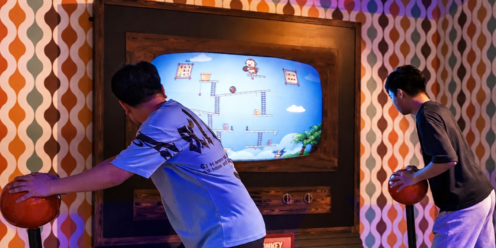 Two young players on the jump pads in the Hangry Monkey room