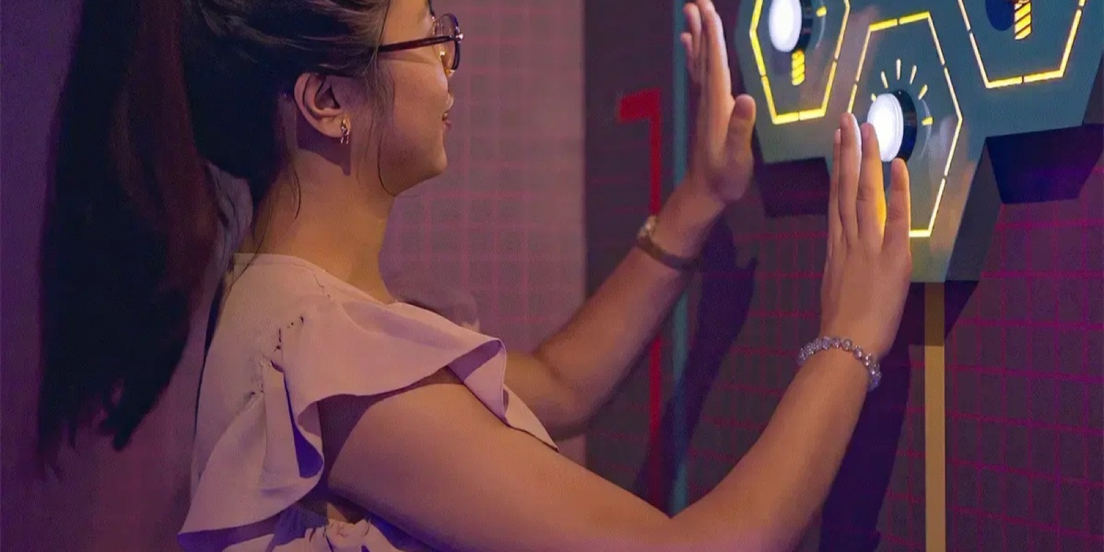 A player pressing the lit panels in the Lights On room