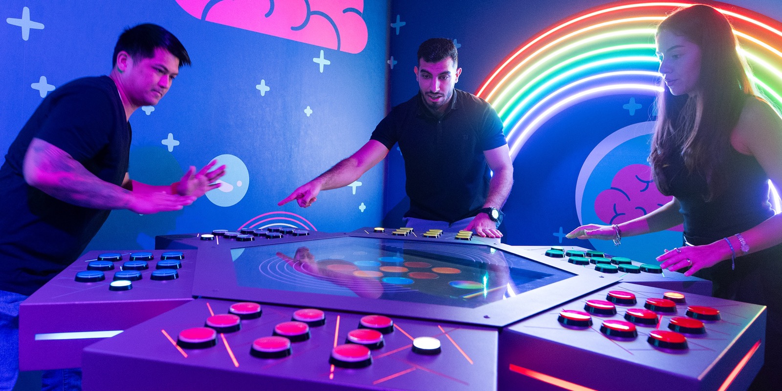 Two players at the colour stations of the Rainbow Mind room