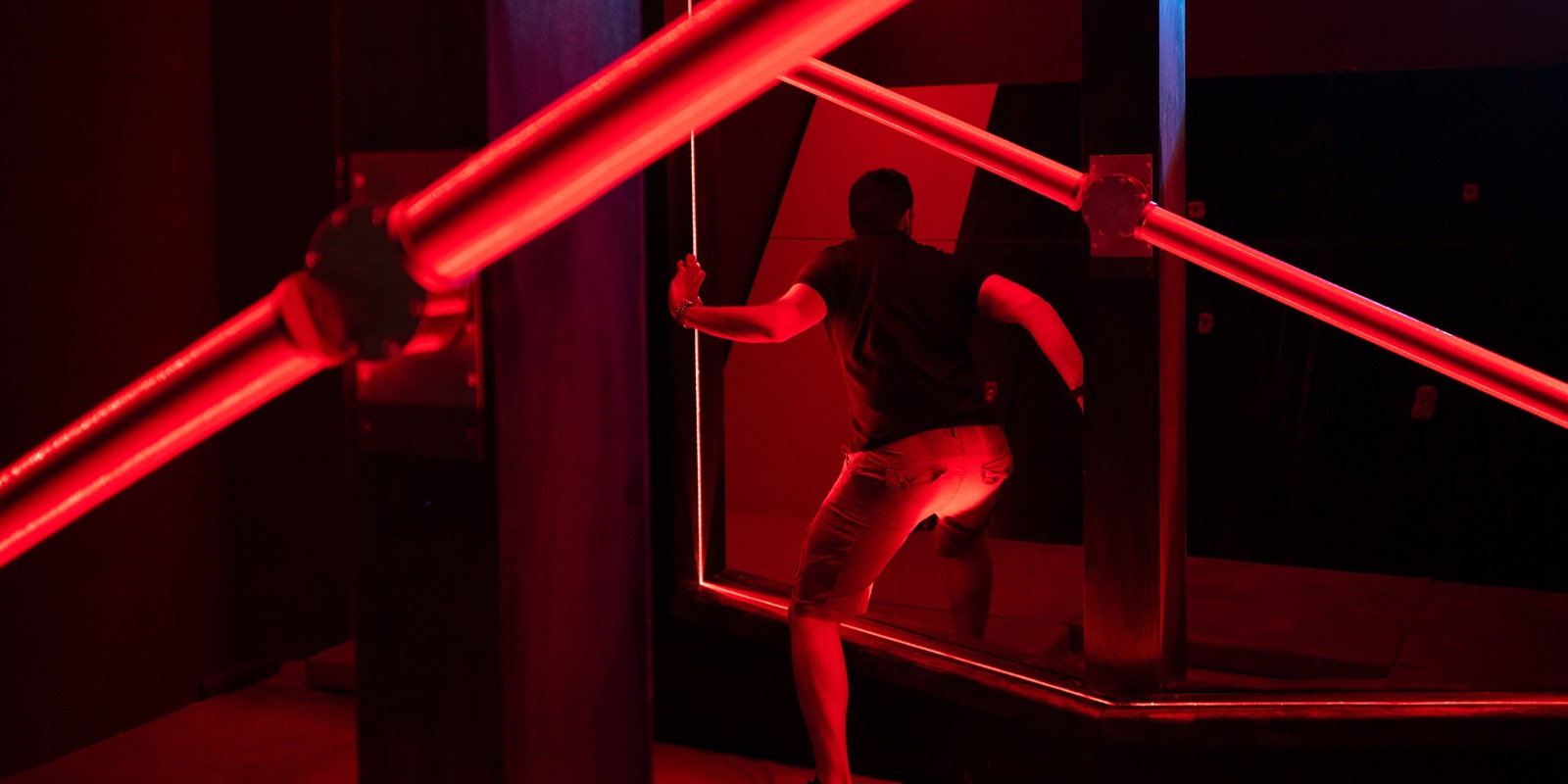 A player climbing in the red-lit Road to Olympus room