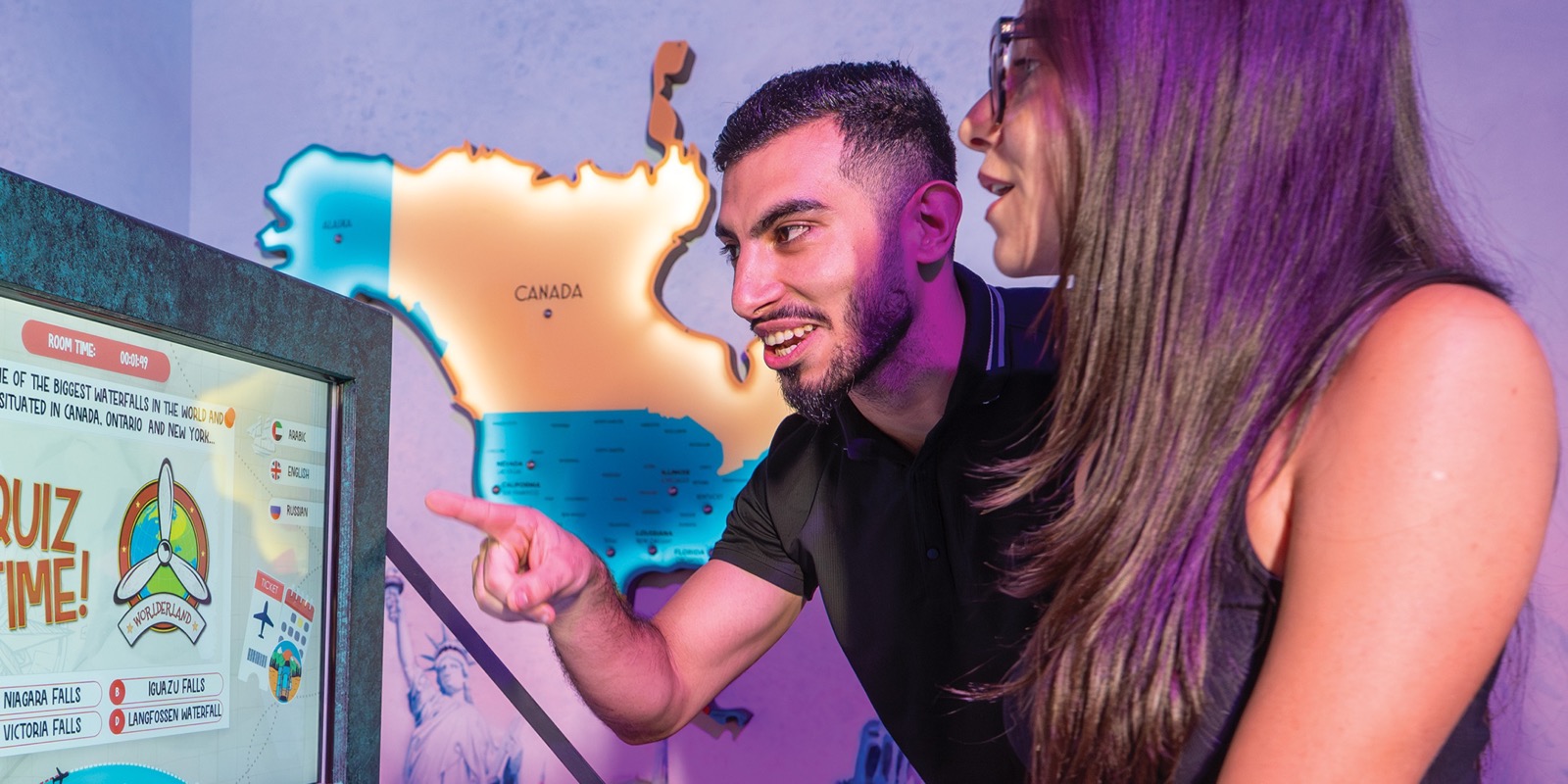 Two players matching photos to countries on the Worlderland map